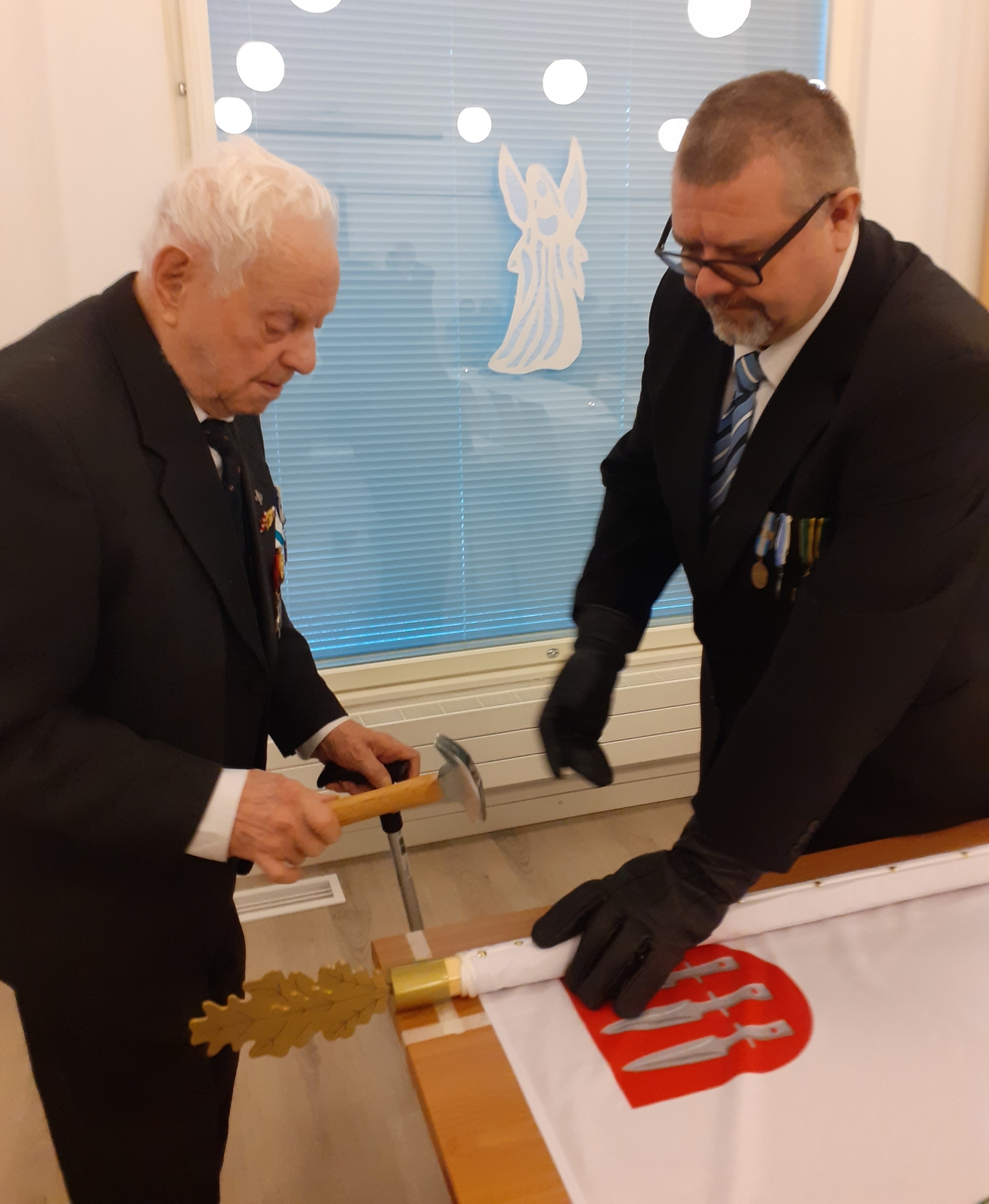 Kuvassa lipun naulaaminen.