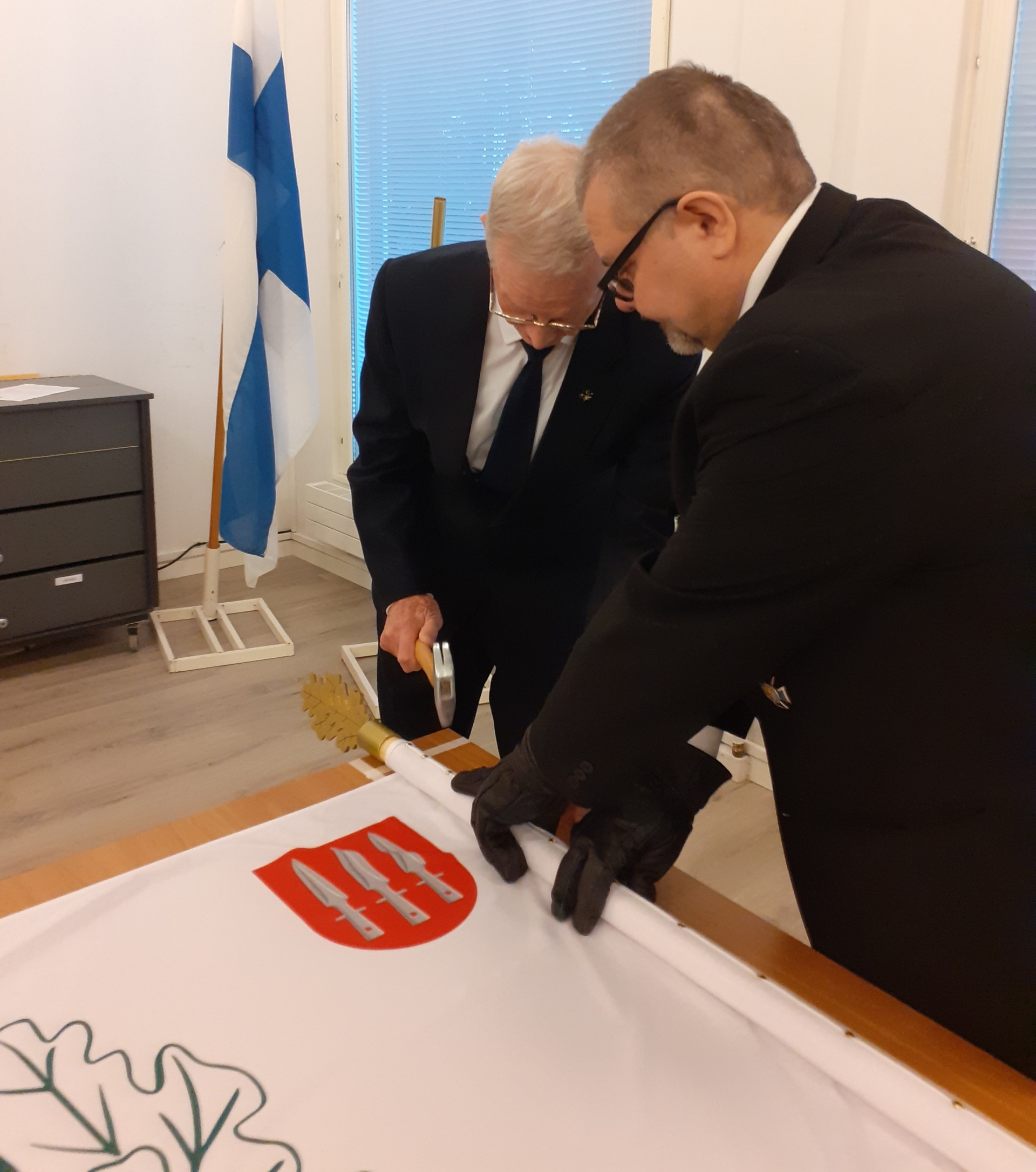 Kuvassa lipun naulaaminen.