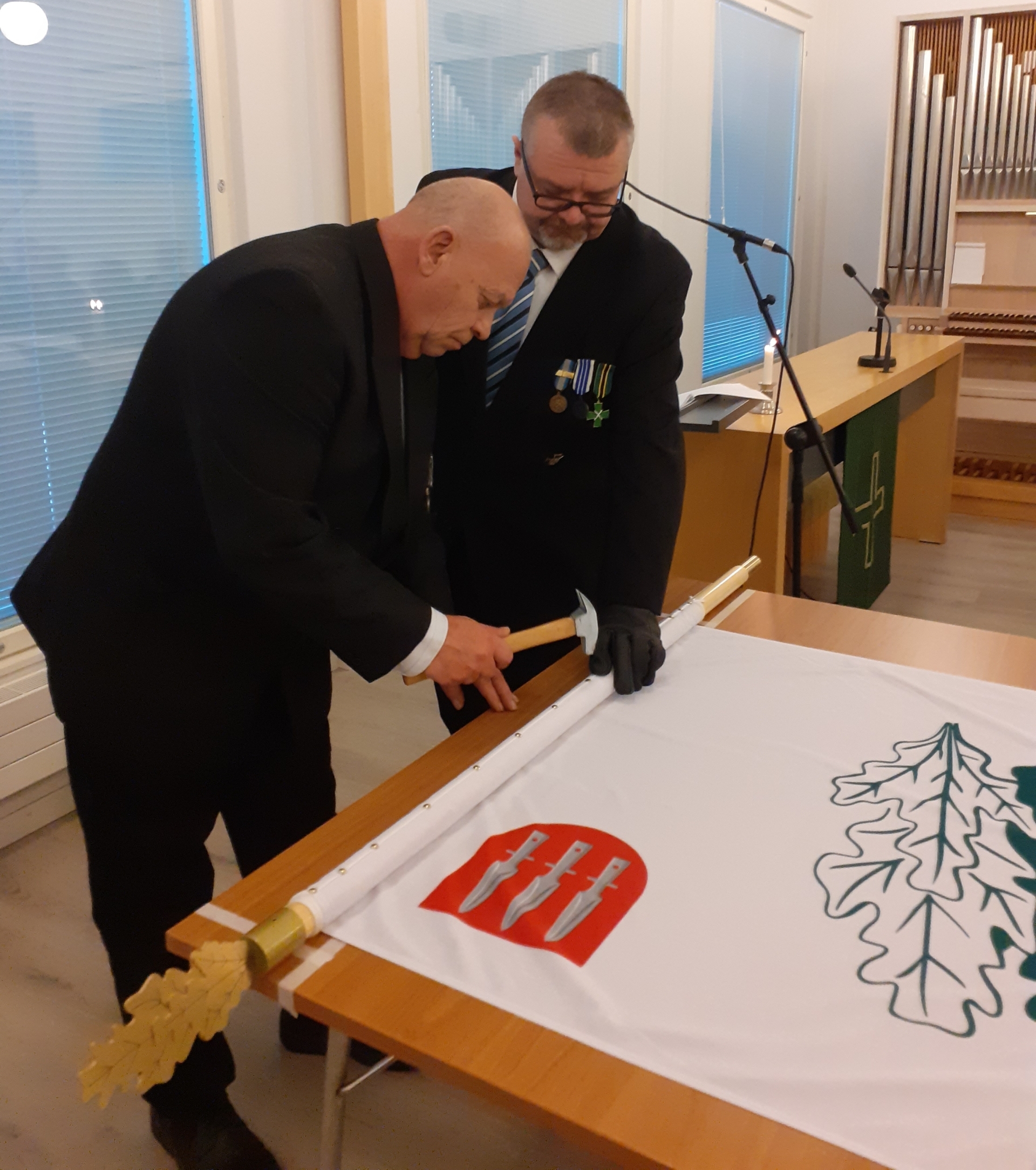 Kuvassa lipun naulaaminen.