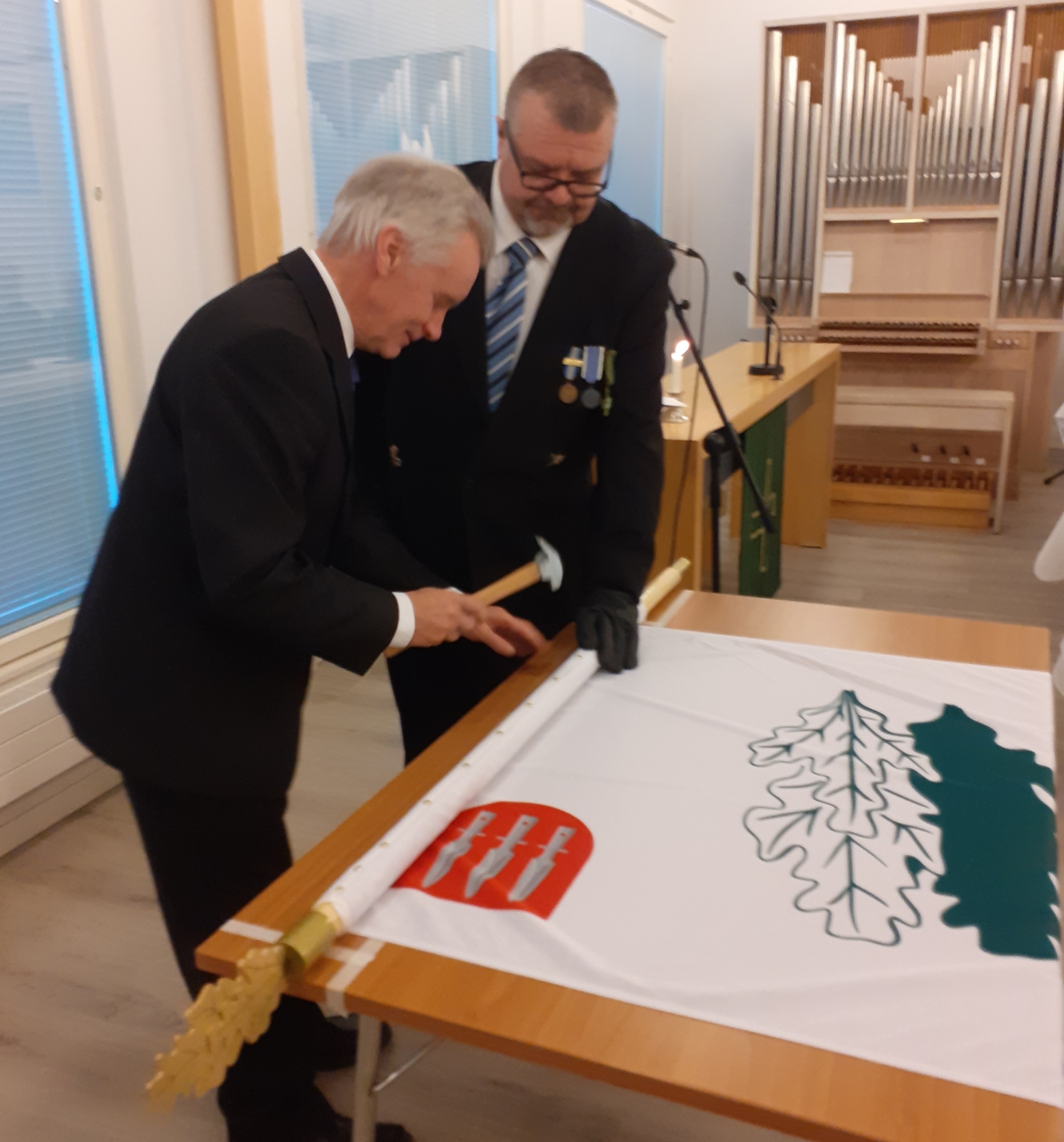 Kuvassa lipun naulaaminen.