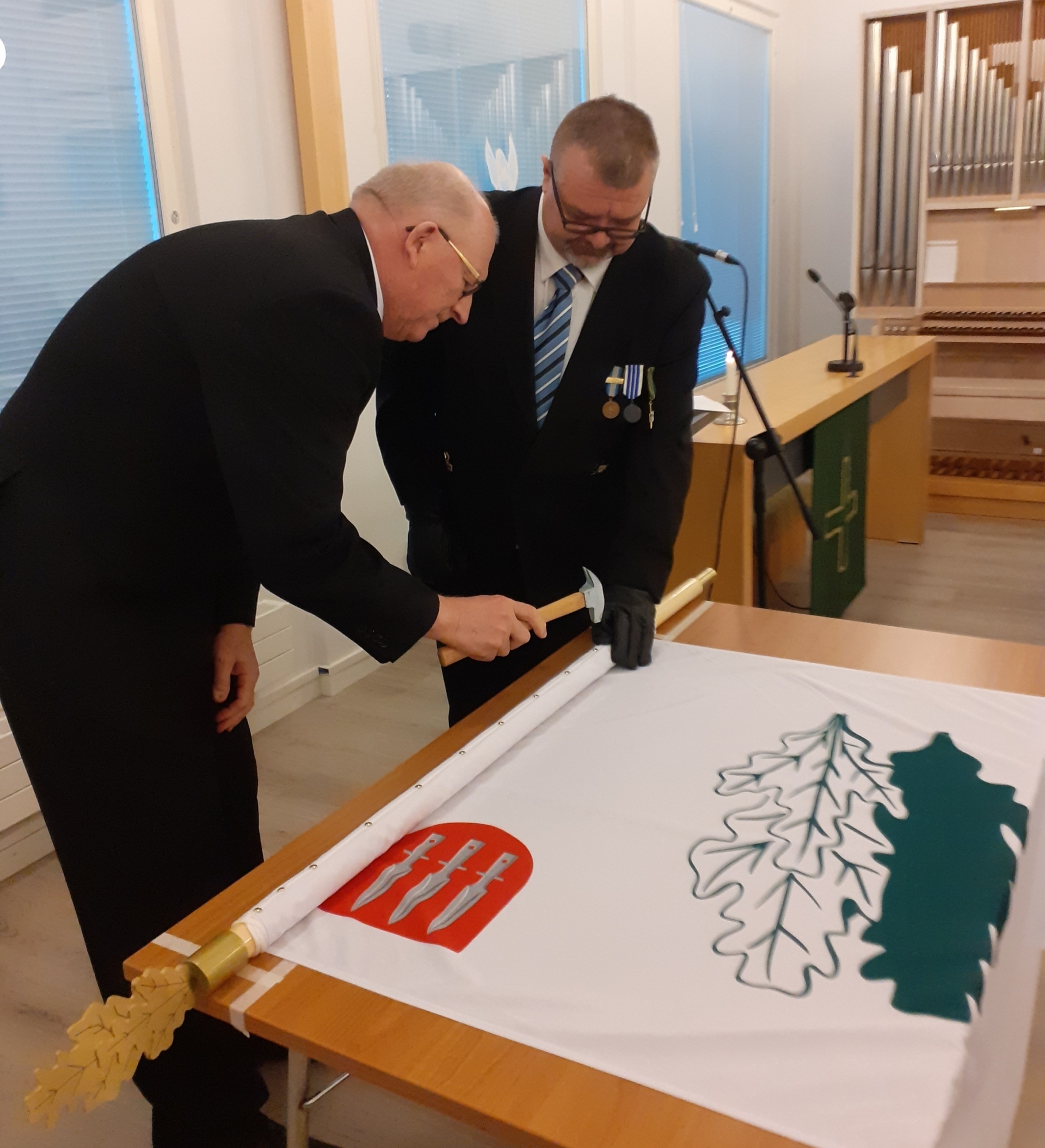 Kuvassa lipun naulaaminen.