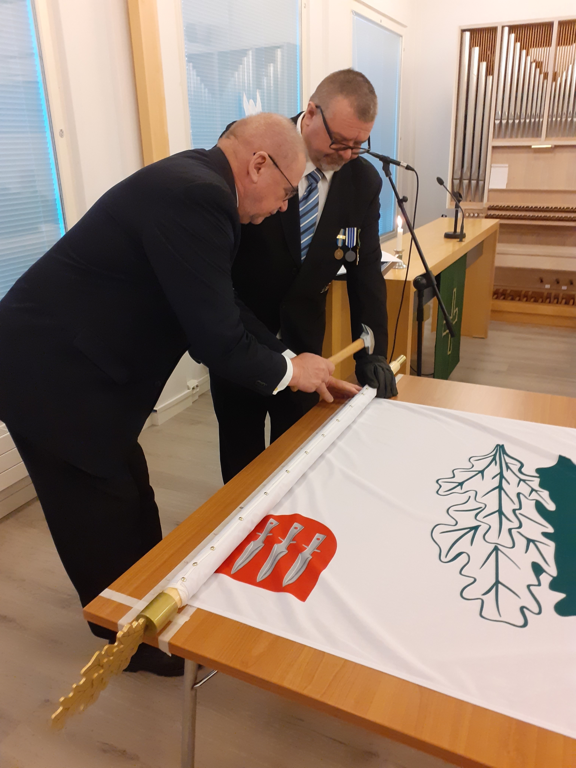 Kuvassa lipun naulaaminen.